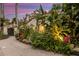 Lush landscaping featuring a variety of plants, flowers, and a brick pathway at 612 Weston Pointe Ct, Longboat Key, FL 34228