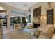 Cozy living room with fireplace and glass doors leading to outdoor pool area at 612 Weston Pointe Ct, Longboat Key, FL 34228