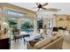 Open-concept living room with large windows overlooking the pool at 612 Weston Pointe Ct, Longboat Key, FL 34228