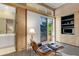 Cozy room with a comfy chair, custom built-ins, and access to a serene outdoor space at 612 Weston Pointe Ct, Longboat Key, FL 34228