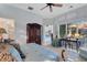 Main bedroom with a dark wood armoire, desk, and large windows offering abundant natural light at 612 Weston Pointe Ct, Longboat Key, FL 34228