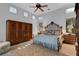 Bright main bedroom with an elegant bed, ornate armoire, dresser, and large windows with plantation shutters at 612 Weston Pointe Ct, Longboat Key, FL 34228