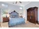 Spacious main bedroom featuring a wooden armoire, dresser, and large windows with plantation shutters at 612 Weston Pointe Ct, Longboat Key, FL 34228