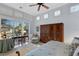 Main bedroom featuring a wooden armoire, desk, and large windows with plantation shutters at 612 Weston Pointe Ct, Longboat Key, FL 34228