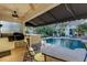 Great outdoor kitchen and lounge area to enjoy while by the pool on summer days at 612 Weston Pointe Ct, Longboat Key, FL 34228