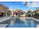 Backyard pool with a built-in bar, lush landscaping and sunny skies at 612 Weston Pointe Ct, Longboat Key, FL 34228