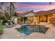 Gorgeous pool and patio with lounge chairs and outdoor dining at dusk at 612 Weston Pointe Ct, Longboat Key, FL 34228