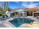 Beautiful pool and patio area surrounded by lush landscaping to enjoy on a sunny afternoon at 612 Weston Pointe Ct, Longboat Key, FL 34228