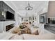 Beautiful living room showcasing a fireplace, modern light fixtures, and neutral color scheme at 6437 Spanish Bayonet Way, Bradenton, FL 34210