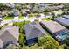 A lush backyard is featured in this aerial shot of the home at 6642 Cheswick St, Sarasota, FL 34243