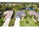 Beautiful aerial view of a well-manicured home with a pond in the backyard at 6642 Cheswick St, Sarasota, FL 34243