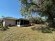 Side of home featuring mature trees, a lanai, and space at 6924 Tuxedo St, Englewood, FL 34224