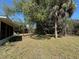 Side of home with large yard, plants and mature trees at 6924 Tuxedo St, Englewood, FL 34224