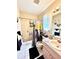 Bright bathroom features a shower-tub combo, pink vanity, and decorative accents for a comfortable experience at 6924 Tuxedo St, Englewood, FL 34224