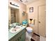 Well-lit bathroom features a large mirror, vanity with storage, toilet, and shower, providing a functional and clean space at 6924 Tuxedo St, Englewood, FL 34224