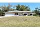 Charming single-story home with well-maintained lawn and covered front porch at 6924 Tuxedo St, Englewood, FL 34224