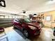 Spacious garage featuring a car, tools, storage, and a large garage door at 6924 Tuxedo St, Englewood, FL 34224