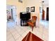 Cozy living room area with tile flooring, comfortable seating, and television at 6924 Tuxedo St, Englewood, FL 34224