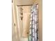 Practical shower area with adjustable shower head, built-in shelving, and a modern shower curtain, designed for convenience at 6924 Tuxedo St, Englewood, FL 34224