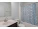 Bright bathroom features a tub-shower with patterned curtain and a single sink vanity at 7406 61St E St, Palmetto, FL 34221