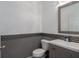 Half bathroom features gray vanity, square sink and a tiled accent wall at 7406 61St E St, Palmetto, FL 34221