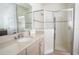 Modern bathroom featuring a glass-enclosed shower, a quartz countertop, and a stylish vanity at 7547 Campus Cv, Sarasota, FL 34243