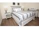 Cozy bedroom with a coastal design, featuring a comfortable bed, decorative pillows, and stylish nightstands at 7547 Campus Cv, Sarasota, FL 34243