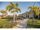 Lush community grounds with mature palm trees and manicured landscaping at 7547 Campus Cv, Sarasota, FL 34243