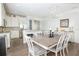 Open-concept dining area featuring modern lighting, a large dining table, and stylish chairs at 7547 Campus Cv, Sarasota, FL 34243
