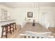 Spacious dining area featuring modern lighting, seating for six, and an adjacent kitchen area at 7547 Campus Cv, Sarasota, FL 34243