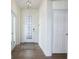 Welcoming entryway featuring modern lighting, a decorative front door, and tile flooring at 7547 Campus Cv, Sarasota, FL 34243