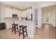 Bright kitchen featuring a breakfast bar, stainless appliances, white cabinets, and modern recessed lighting at 7547 Campus Cv, Sarasota, FL 34243