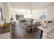 Open concept living area features tile flooring, modern light fixture, and access to screened in patio at 7547 Campus Cv, Sarasota, FL 34243