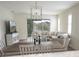 Open concept living area features tile flooring, modern light fixture, and access to screened in patio at 7547 Campus Cv, Sarasota, FL 34243