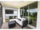 Screened in lanai features tile flooring and comfortable outdoor seating at 7547 Campus Cv, Sarasota, FL 34243