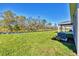 Large backyard with green grass and lush landscaping at 818 170Th E Ct, Bradenton, FL 34212