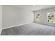 Spacious bedroom featuring neutral paint, soft carpet and plenty of natural light creating a bright and airy living space at 818 170Th E Ct, Bradenton, FL 34212