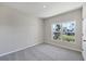 Cozy bedroom with neutral carpet, a large window providing natural light, and ample space at 818 170Th E Ct, Bradenton, FL 34212