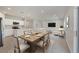 Open dining area featuring neutral decor and lots of space for entertaining adjacent to the kitchen and living room at 818 170Th E Ct, Bradenton, FL 34212