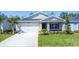 Charming single-story home with a two-car garage, manicured lawn, and inviting curb appeal at 818 170Th E Ct, Bradenton, FL 34212