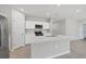 Beautiful kitchen with white cabinets, stainless appliances and an island with breakfast bar at 818 170Th E Ct, Bradenton, FL 34212