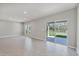 Bright living room features tile flooring, recessed lighting, and sliding glass doors to the backyard at 818 170Th E Ct, Bradenton, FL 34212