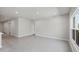 This living room offers tile flooring, recessed lighting, and a large window overlooking the backyard at 818 170Th E Ct, Bradenton, FL 34212