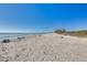 Expansive beach view with soft sand and clear blue water at 8635 Midnight Pass Rd # C201, Sarasota, FL 34242