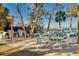 Inviting outdoor patio with multiple grills, picnic tables, and boat dock access for relaxing waterfront dining at 8635 Midnight Pass Rd # 201C, Sarasota, FL 34242