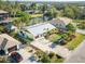 Aerial view of a charming property with defined borders, featuring mature landscaping and water access at 9031 Hilolo Ln, Venice, FL 34293