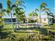 The backyard features mature landscaping including palm trees at 9031 Hilolo Ln, Venice, FL 34293