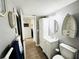 Narrow bathroom with gray walls, white vanity, and a toilet at 9031 Hilolo Ln, Venice, FL 34293