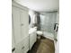Modern bathroom featuring a toilet, vanity, custom storage and walk-in shower at 9031 Hilolo Ln, Venice, FL 34293