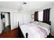 Cozy bedroom with a queen bed, ceiling fan, and closet space at 9031 Hilolo Ln, Venice, FL 34293